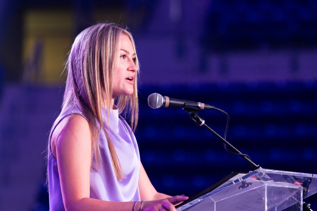 A young woman presents at the podium.