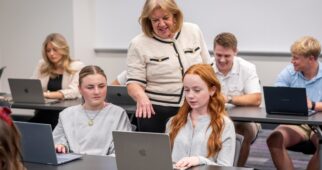 Educator helping students as they work and learn.