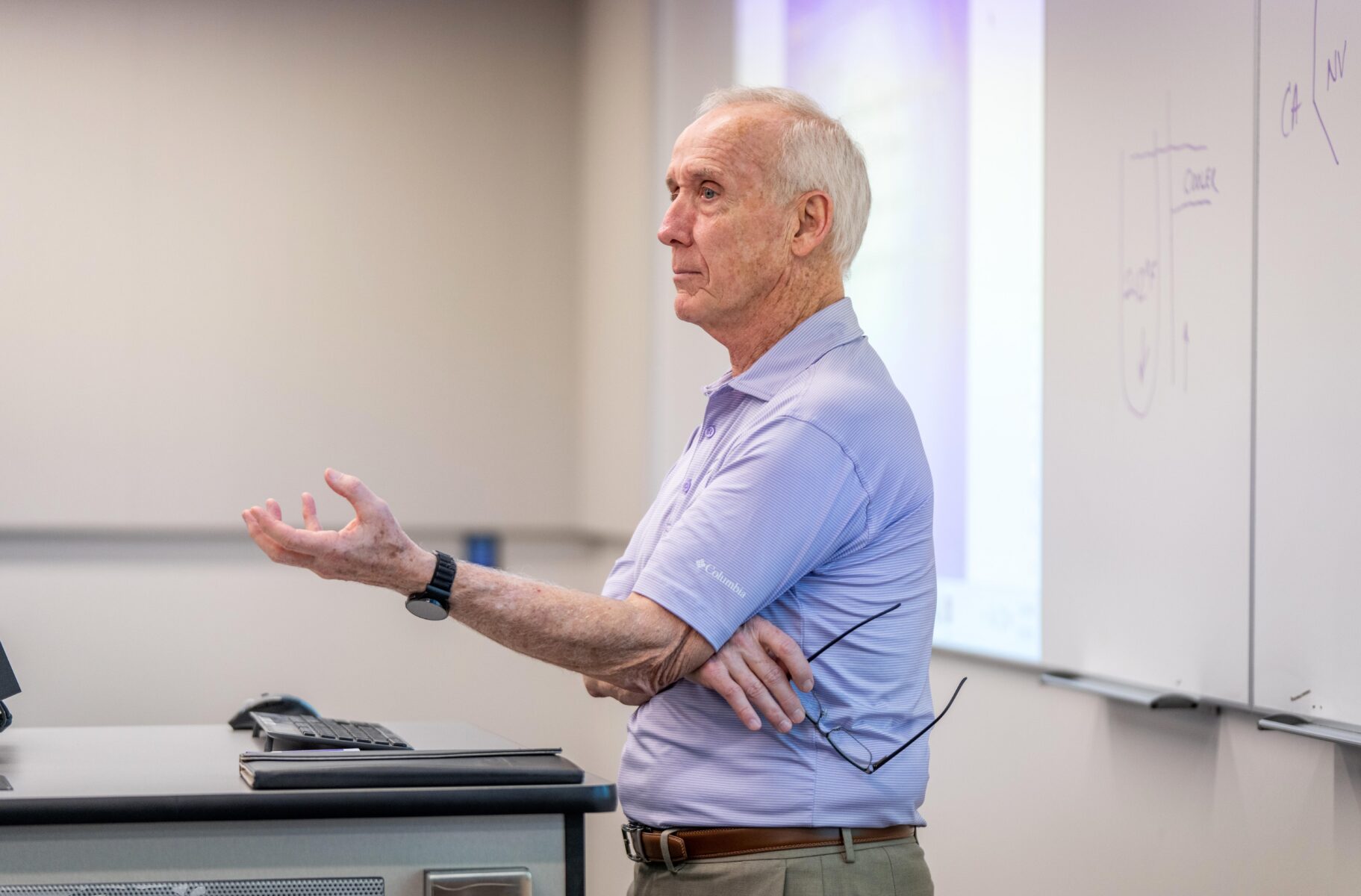 Older Instructor lectures a class